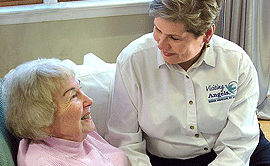 Visiting Angels employee helping elderly woman